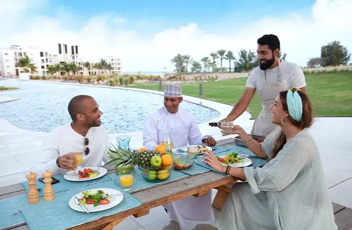 people having lunch on the pool