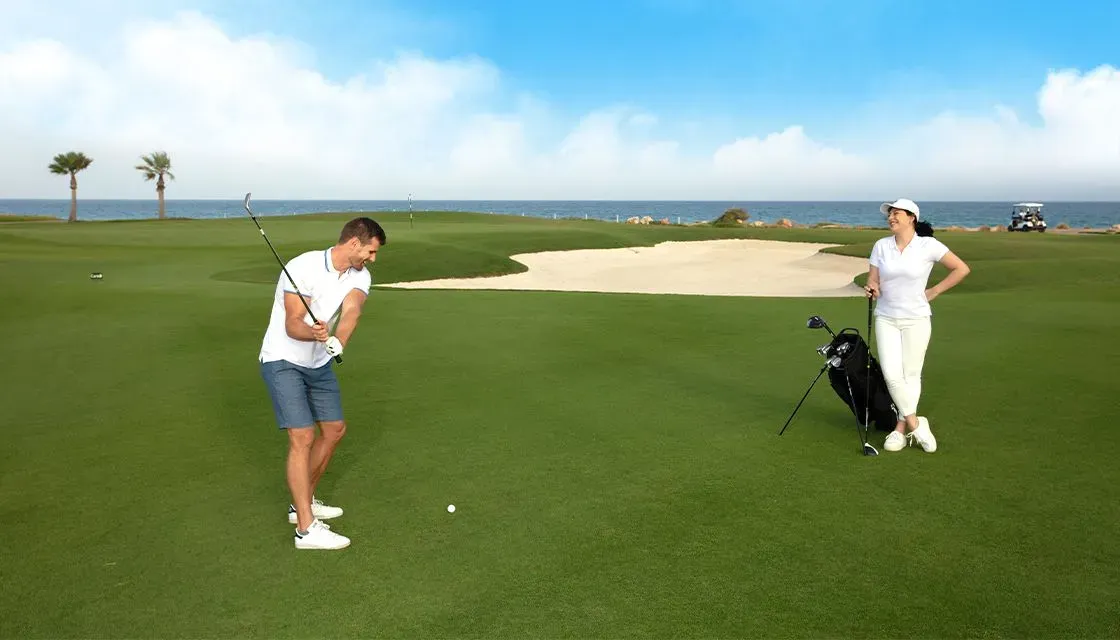 two people playing golf