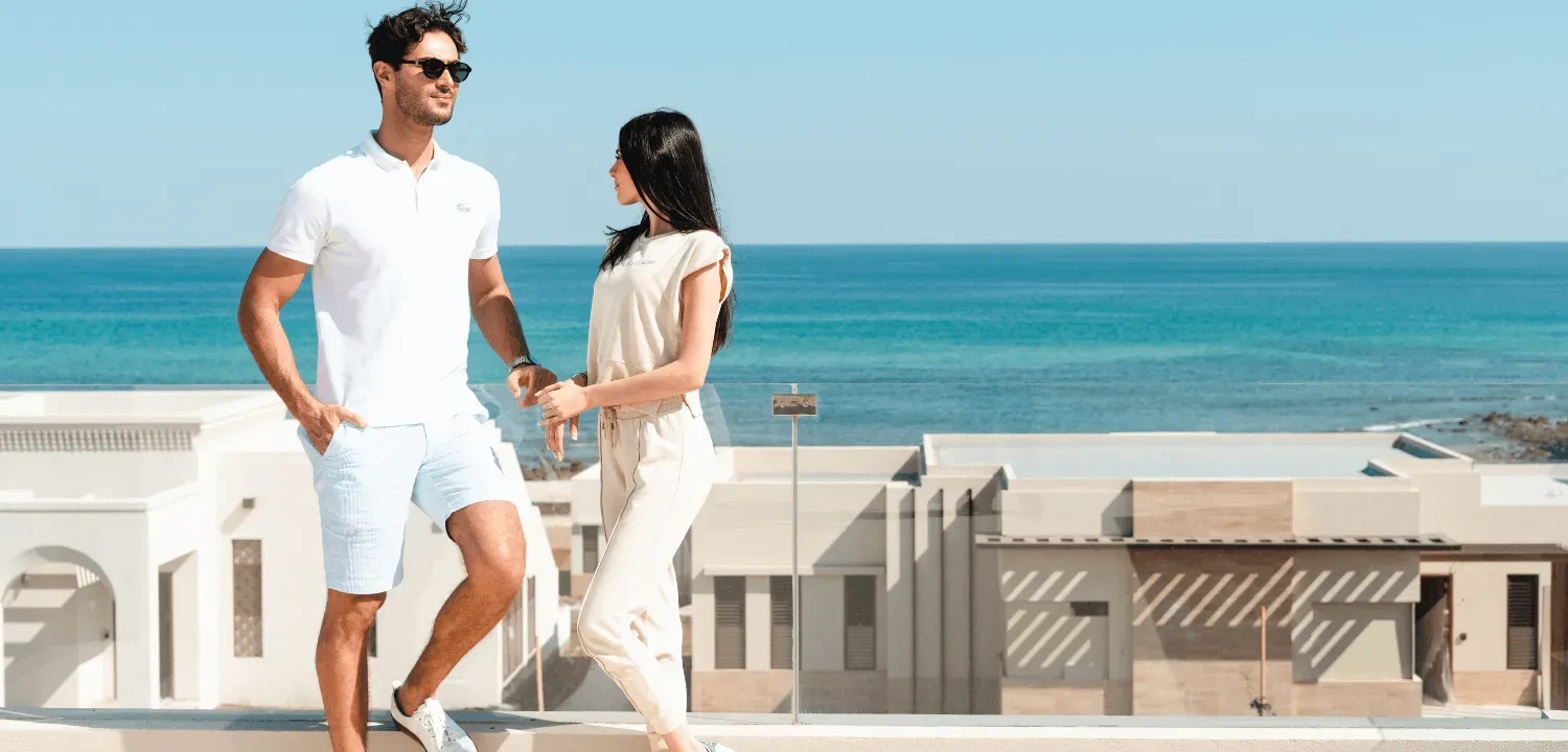 man and woman enjoyiong sea view